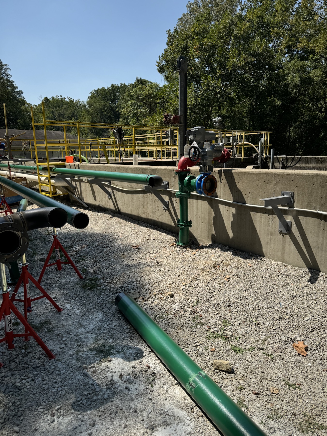 Exterior water treatment piping and valve work at an active facility