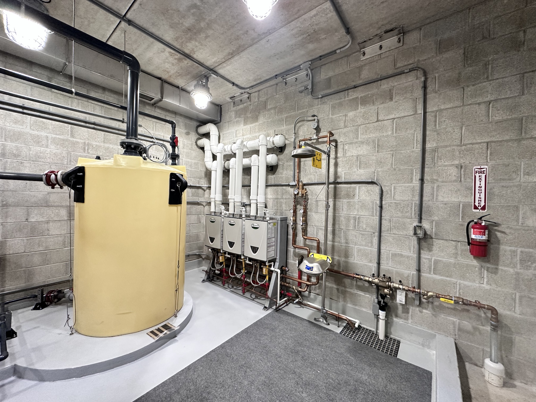 Clean utility room installation with heaters and piping